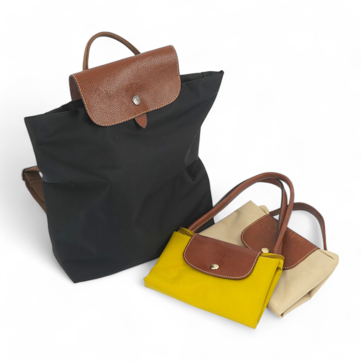 A Longchamps black rucksack, a shoulder bag and a briefcase bag